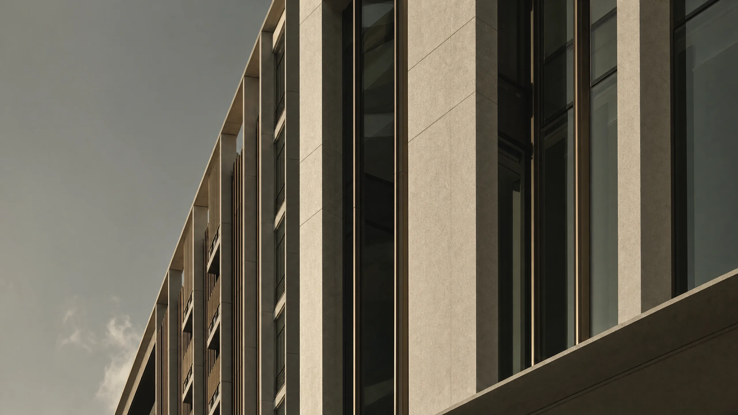 Contemporary tropical modernist architecture detail with geometric concrete facade and bronze accents at golden hour.